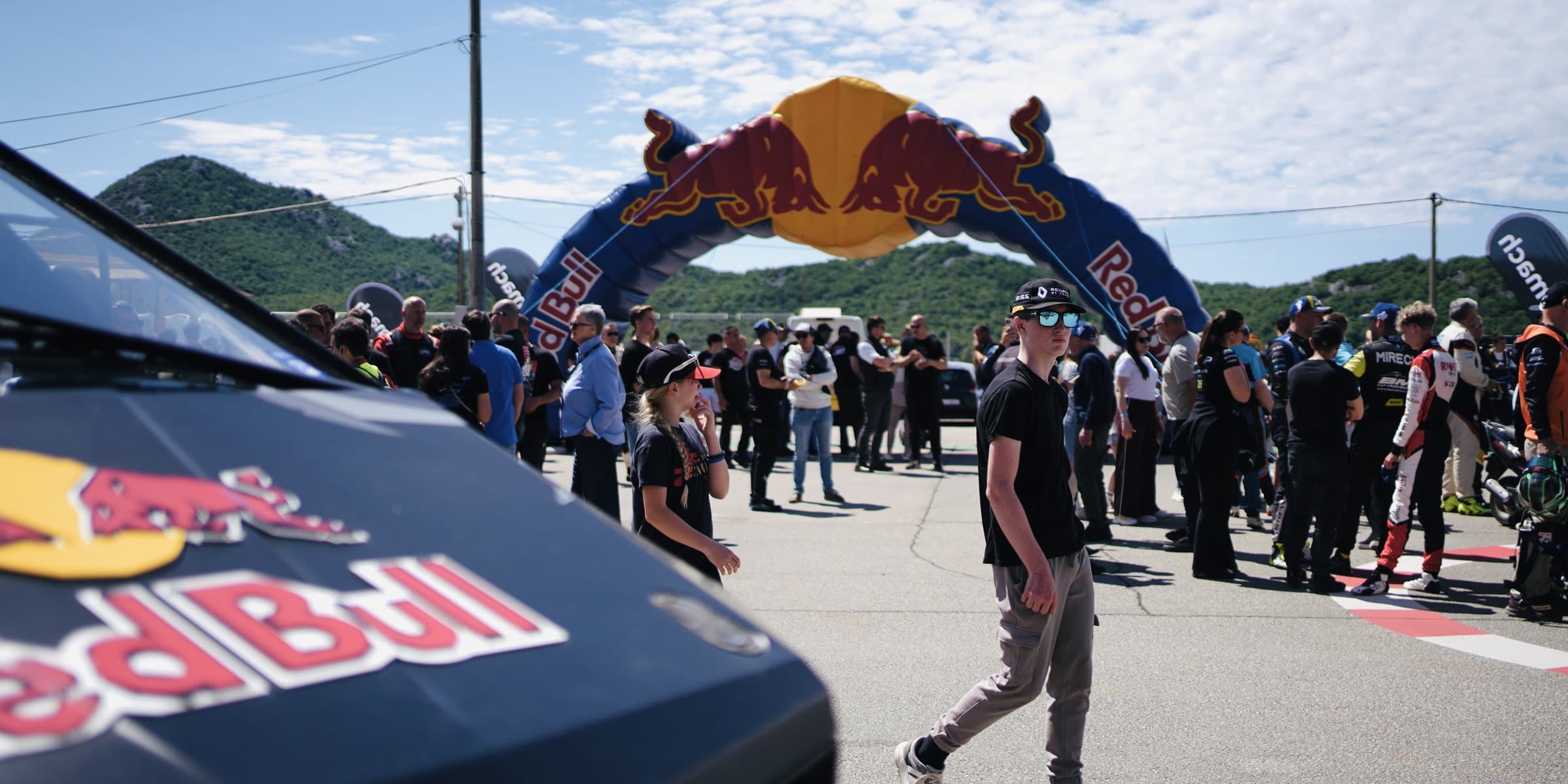 Fans and drivers under the Red Bull arch at the fan zone entrance