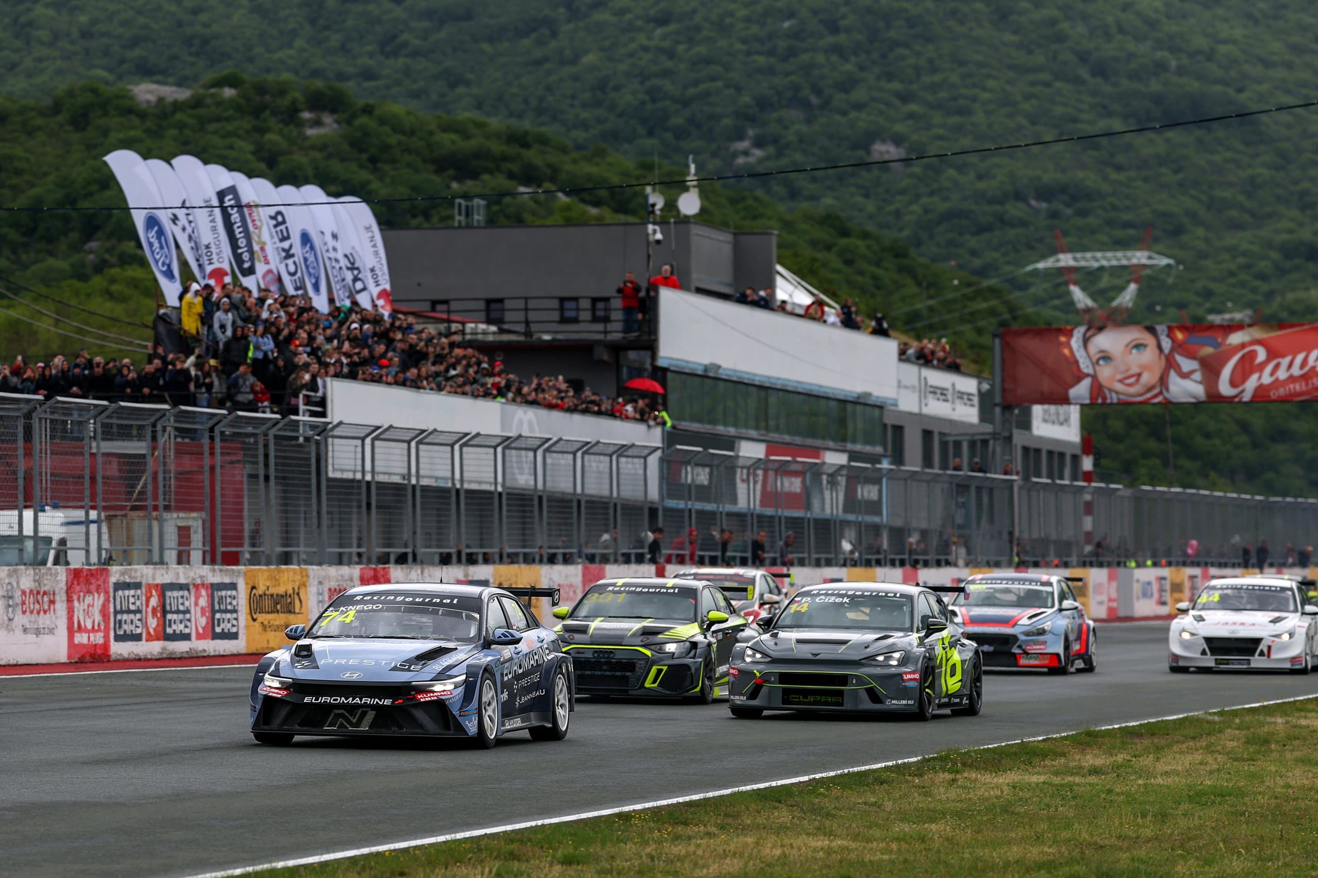 TCR cars on the main straight at Grobnik, a full grandstand behind them