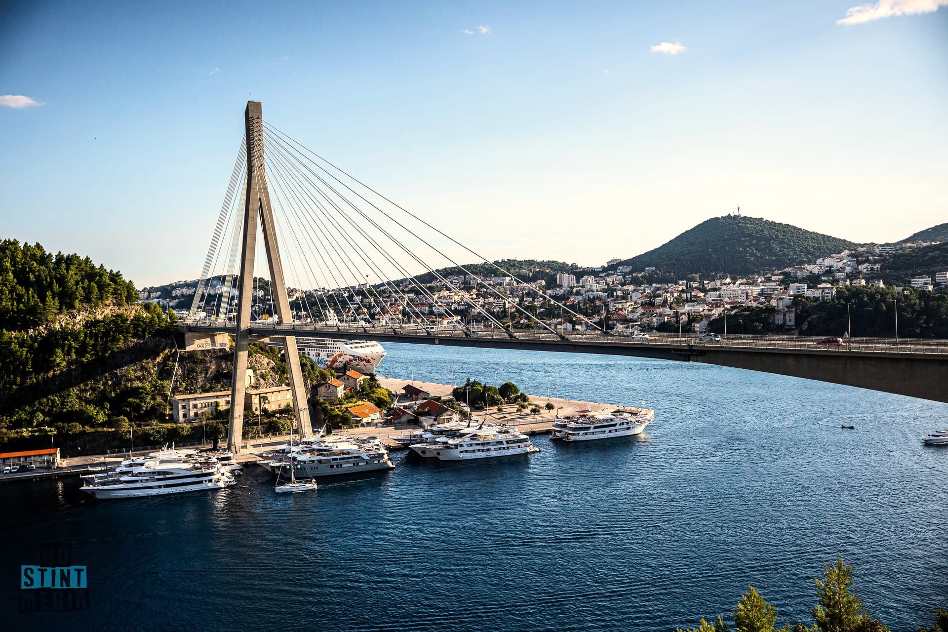 The Dubrovnik bridge and the bay in the afternoon sun, boats at the marina
